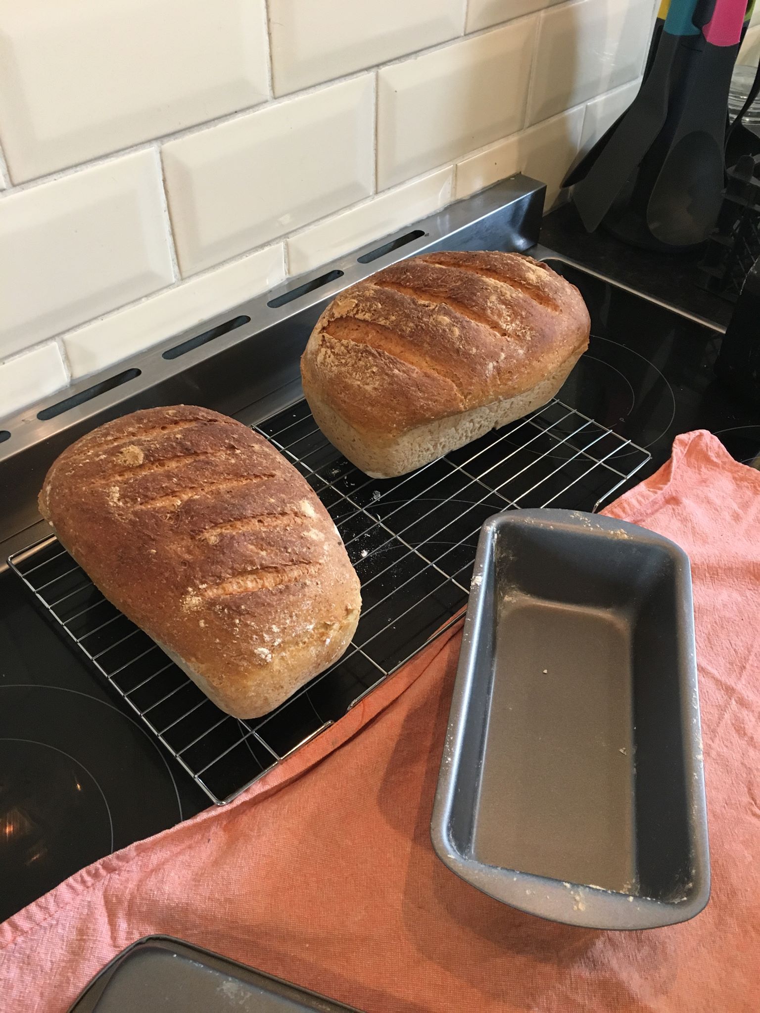 two finished loaves, wholemeal and plain white flour